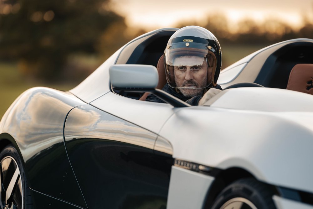 A helmeted test driver signing off a Speedster on the road