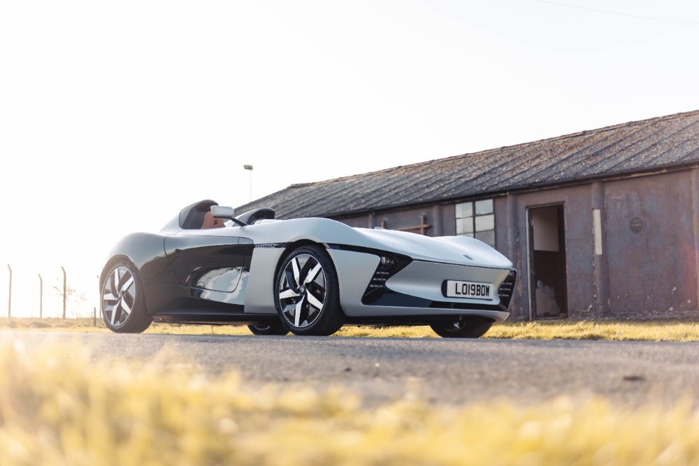 The Speedster parked beside an old airfield building